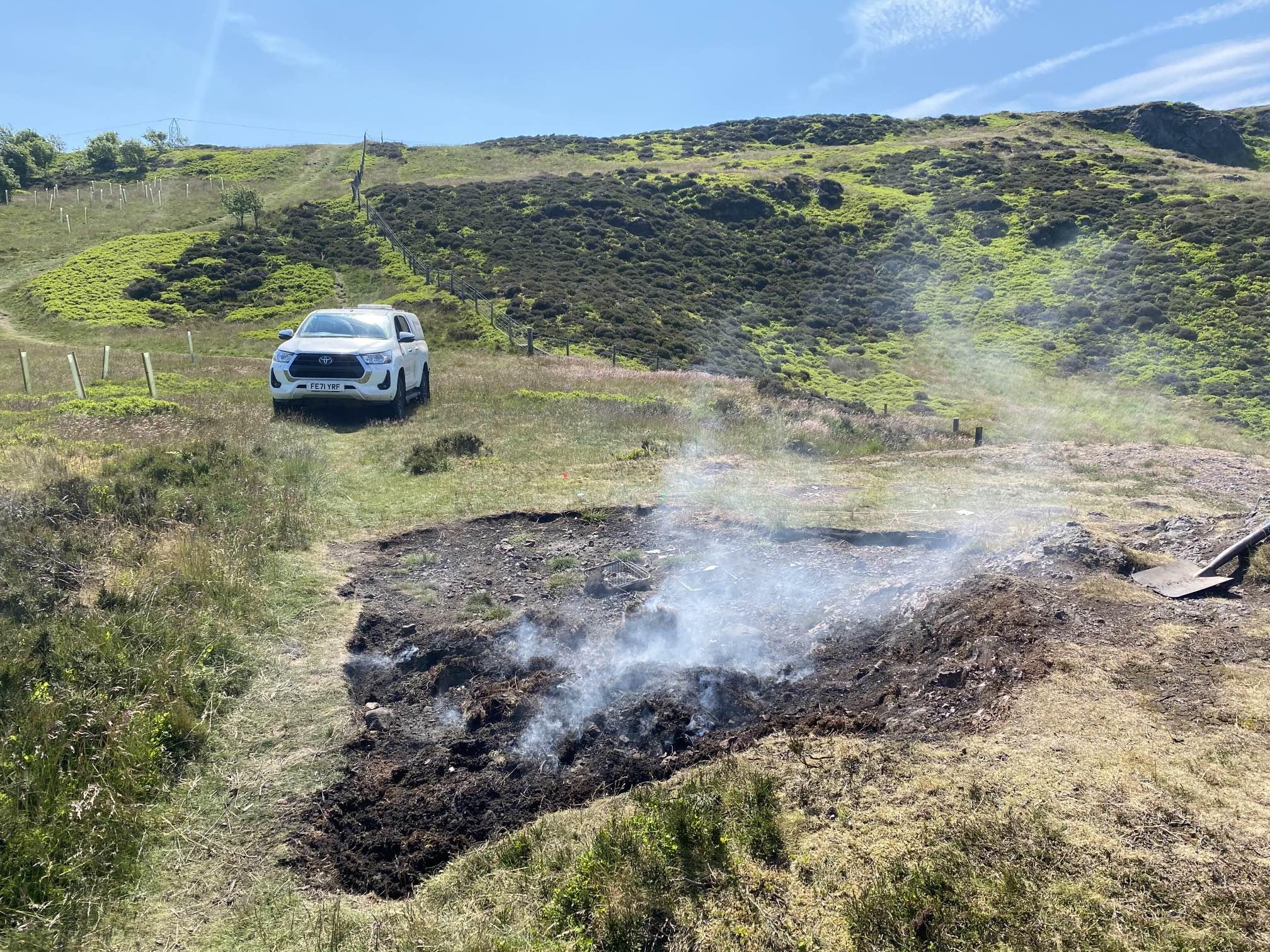 Smouldering fire on top of hill